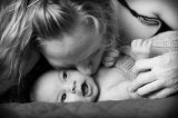 Mother kissing her smiling baby